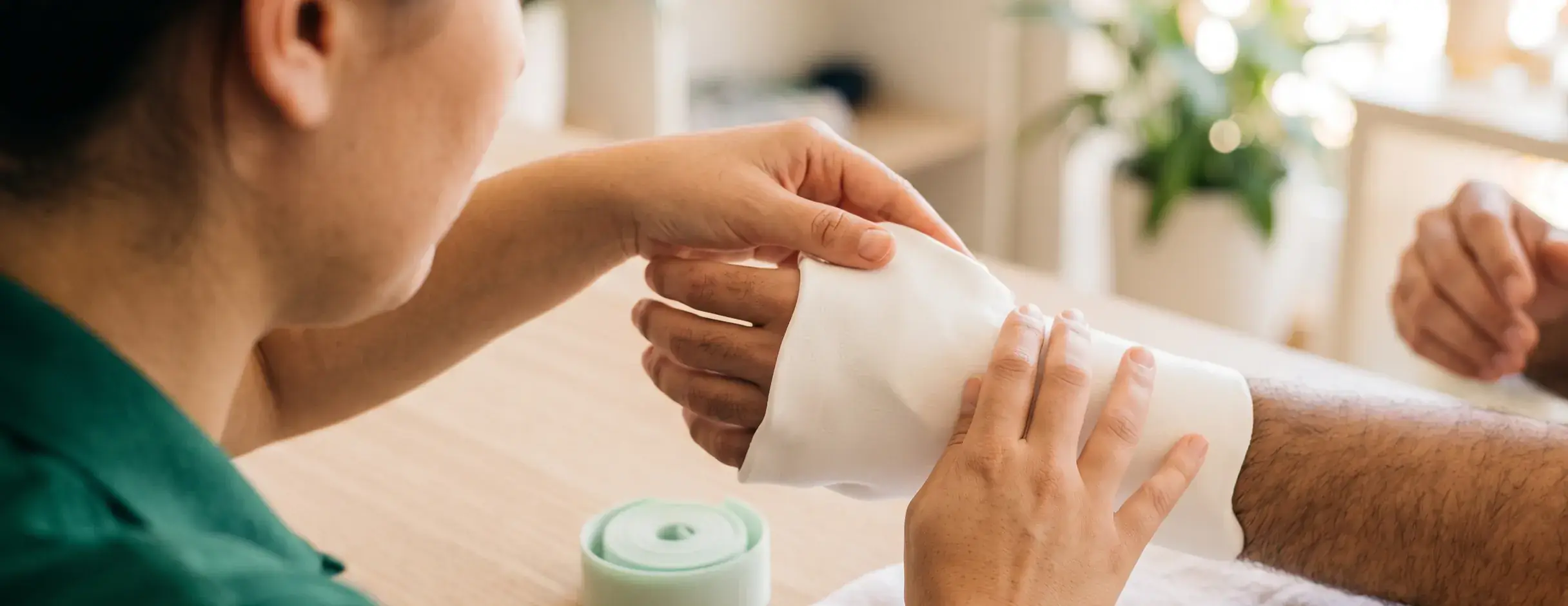 A therapist shapes a thermoplastic hand splint on the wrist